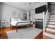 Bedroom featuring wood floors, ceiling fan, and a bed with an iron frame at 545 Fletcher Ave, Indianapolis, IN 46203
