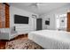 Bedroom with hardwood floors, neutral decor, and a TV at 545 Fletcher Ave, Indianapolis, IN 46203