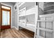 White bunk beds with white ladders in a modern bedroom with wood-look floors at 545 Fletcher Ave, Indianapolis, IN 46203