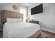Comfortable bedroom with large bed, wall-mounted TV, and bright natural lighting at 545 Fletcher Ave, Indianapolis, IN 46203