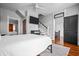 Bedroom with hardwood floors, TV, staircase, and access to other rooms at 545 Fletcher Ave, Indianapolis, IN 46203