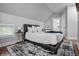 Comfortable bedroom with a plush queen-sized bed, side table, and bright window at 545 Fletcher Ave, Indianapolis, IN 46203
