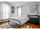 Bright bedroom with hardwood floors, accent rug, and modern black metal bed frame at 545 Fletcher Ave, Indianapolis, IN 46203