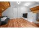 Bonus room with wood floors, neutral walls, TV, sofa, and stairway entrance at 545 Fletcher Ave, Indianapolis, IN 46203