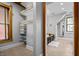 Walk-in closet with wood shelves and tile flooring, leading to a bathroom at 545 Fletcher Ave, Indianapolis, IN 46203