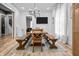 Bright dining room with wooden table, benches, and modern chandelier at 545 Fletcher Ave, Indianapolis, IN 46203