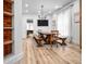 Bright dining room features rustic wood table, benches, modern chandelier, and light-toned floors at 545 Fletcher Ave, Indianapolis, IN 46203