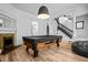 Game room with a pool table, decorative fireplace, and views of the staircase at 545 Fletcher Ave, Indianapolis, IN 46203