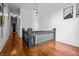 Hallway with wood floors, natural light, black painted door, and art on the walls at 545 Fletcher Ave, Indianapolis, IN 46203