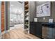 Hallway with black beverage cooler, open shelves, and a peek into the living room at 545 Fletcher Ave, Indianapolis, IN 46203