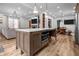 Open-concept kitchen with island, stainless steel oven, and adjacent living spaces at 545 Fletcher Ave, Indianapolis, IN 46203