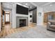 Cozy living room with a fireplace, mounted TV, and a view into the adjacent kitchen at 545 Fletcher Ave, Indianapolis, IN 46203