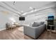 Finished living room with wood laminate floors, neutral paint, gaming system and seating at 545 Fletcher Ave, Indianapolis, IN 46203