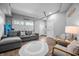 Spacious living area with a comfortable gray sofa and seating near a garage door at 545 Fletcher Ave, Indianapolis, IN 46203
