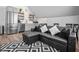 Stylish living and kitchen area with stainless steel appliances and sleek black leather sofa at 545 Fletcher Ave, Indianapolis, IN 46203