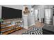 Bright open living space with a large TV, modern shelving, and stainless steel refrigerator at 545 Fletcher Ave, Indianapolis, IN 46203