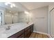 Bathroom featuring a double vanity with dark wood cabinets and a tiled shower at 6038 Windsor Dr, McCordsville, IN 46055