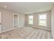 Light-filled bedroom with neutral carpet, two windows, and a walk-in closet at 6038 Windsor Dr, McCordsville, IN 46055