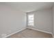 This carpeted bedroom is a blank canvas with neutral walls and a window for natural light at 6038 Windsor Dr, McCordsville, IN 46055