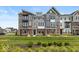 Charming multi-level townhomes boast manicured lawns and eye-catching brick and siding combinations at 6038 Windsor Dr, McCordsville, IN 46055