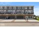 Exterior of a gray and brick townhouse with balconies and two-car garages at 6038 Windsor Dr, McCordsville, IN 46055