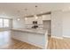 Bright kitchen featuring stainless appliances, subway tile backsplash, and a large island at 6038 Windsor Dr, McCordsville, IN 46055