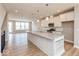 Bright, open kitchen with a large island, modern light fixtures, and stainless steel appliances at 6038 Windsor Dr, McCordsville, IN 46055