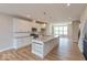 Bright, open kitchen with a large island, modern light fixtures, and stainless steel appliances at 6038 Windsor Dr, McCordsville, IN 46055