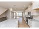 Bright, open kitchen with a large island, modern light fixtures, and stainless steel appliances at 6038 Windsor Dr, McCordsville, IN 46055