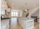 Bright, open kitchen with a large island, modern light fixtures, and stainless steel appliances at 6038 Windsor Dr, McCordsville, IN 46055