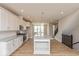 Bright, open kitchen with a large island, modern light fixtures, and stainless steel appliances at 6038 Windsor Dr, McCordsville, IN 46055