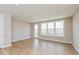 Spacious living room with wood flooring and large windows allowing for plenty of natural light at 6038 Windsor Dr, McCordsville, IN 46055
