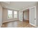 Light-filled living room features hardwood floors and glass paneled french doors to another room at 6038 Windsor Dr, McCordsville, IN 46055