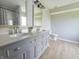 Bathroom featuring double sinks with gray cabinets and modern fixtures at 6369 Kelsey Dr, Indianapolis, IN 46268