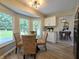 Cozy dining area features natural light, a glass table, and a view to the outside deck at 6369 Kelsey Dr, Indianapolis, IN 46268