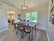 Elegant dining room with modern lighting, stylish decor, and an adjacent living area at 6369 Kelsey Dr, Indianapolis, IN 46268