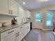 Modern kitchen with white cabinets, granite countertops, and stainless steel appliances at 6369 Kelsey Dr, Indianapolis, IN 46268