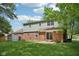 A spacious backyard is showcased, featuring a lush green lawn, brick exterior, and mature trees at 6838 Johnson Rd, Indianapolis, IN 46220