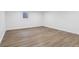 Basement with light wood laminate flooring and a window providing natural light at 6838 Johnson Rd, Indianapolis, IN 46220