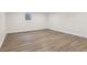 Spacious basement featuring wood-look flooring and a window, offering a versatile living area at 6838 Johnson Rd, Indianapolis, IN 46220