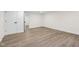 Finished basement featuring wood-look flooring, doors, and ample space for various activities at 6838 Johnson Rd, Indianapolis, IN 46220