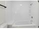 Clean bathroom with a white tub and shower combination with neutral walls and hardware at 6838 Johnson Rd, Indianapolis, IN 46220