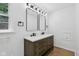 Bathroom featuring a double vanity with a countertop, mirrors, and modern lighting at 6838 Johnson Rd, Indianapolis, IN 46220