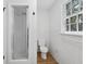 Clean bathroom with glass shower, toilet, and window with natural light at 6838 Johnson Rd, Indianapolis, IN 46220