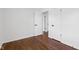 Bedroom with neutral walls, warm hardwood floors, and multiple closets, great for storage at 6838 Johnson Rd, Indianapolis, IN 46220