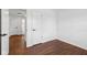 Clean bedroom with warm wood floors and a door to the hall and ensuite bathroom at 6838 Johnson Rd, Indianapolis, IN 46220
