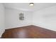 Cozy bedroom with hardwood floors and a window providing natural light and a view of the outdoors at 6838 Johnson Rd, Indianapolis, IN 46220