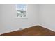 Bedroom featuring hardwood floors, neutral walls, and a bright window at 6838 Johnson Rd, Indianapolis, IN 46220