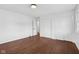 Bright bedroom featuring hardwood floors, white walls, and double closets, perfect for comfortable living at 6838 Johnson Rd, Indianapolis, IN 46220