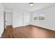 Bright bedroom with beautiful dark wood floors, white walls, and double closets for ample storage space at 6838 Johnson Rd, Indianapolis, IN 46220